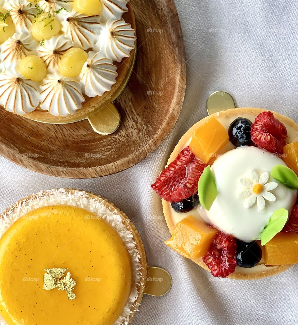 Beautiful and colourful fruit tarts that make a happy day. Lemon meringue, raspberry, passion fruit feast.