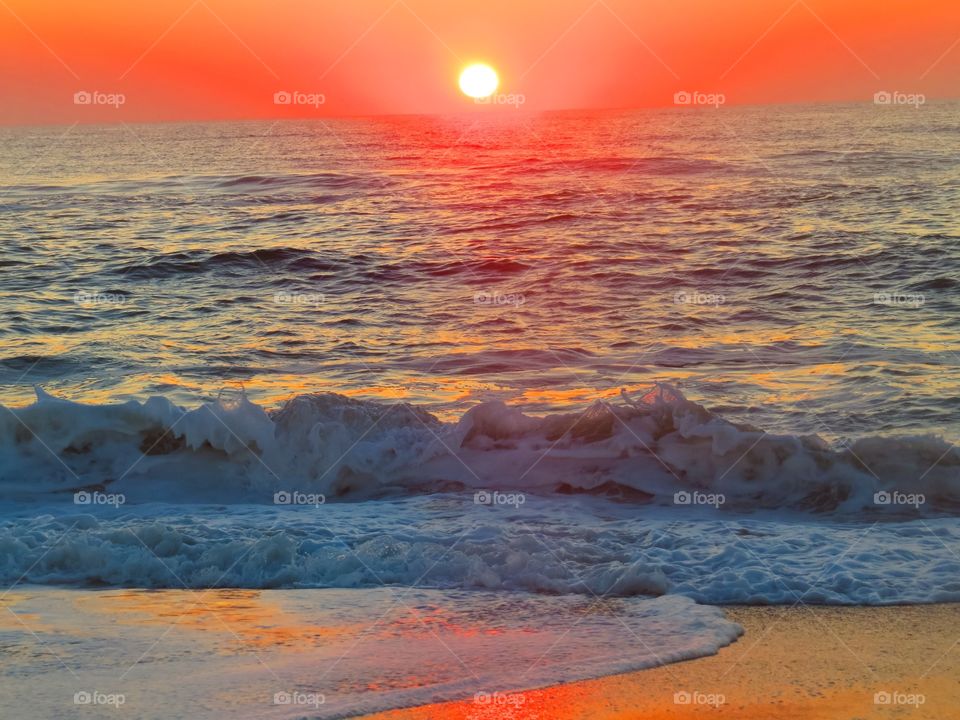 View of seascape at sea during sunset