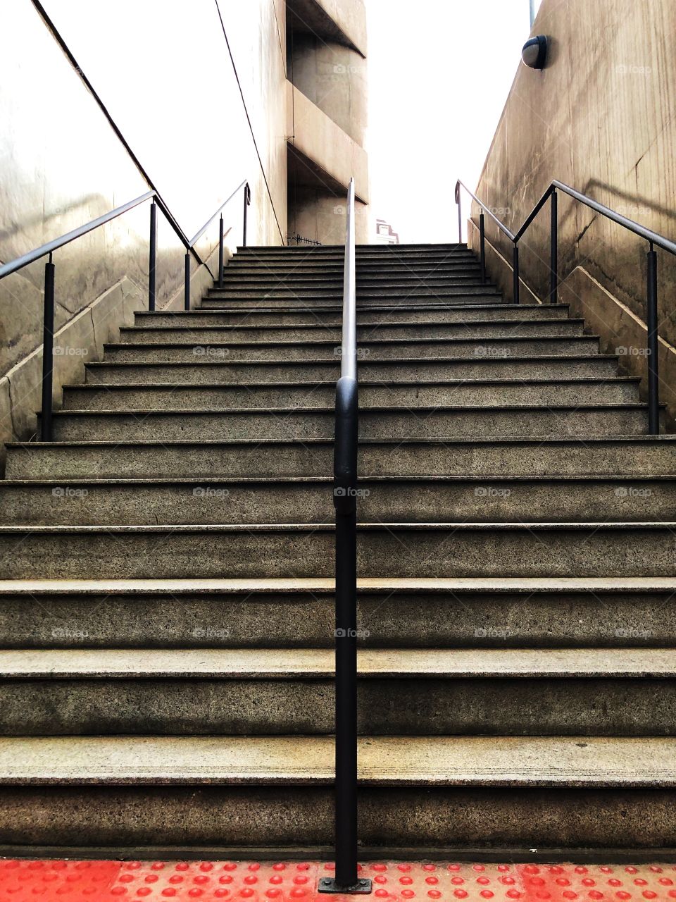 Playing with symmetry in the stairs... Concrete and Steel, but very charming and elegant.