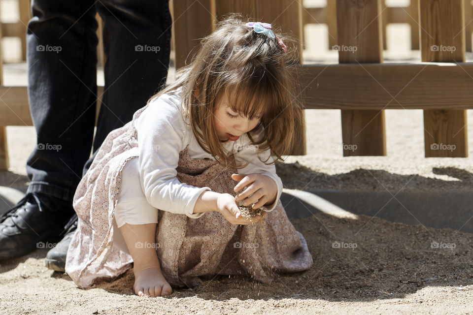 Cute girl playing in sand