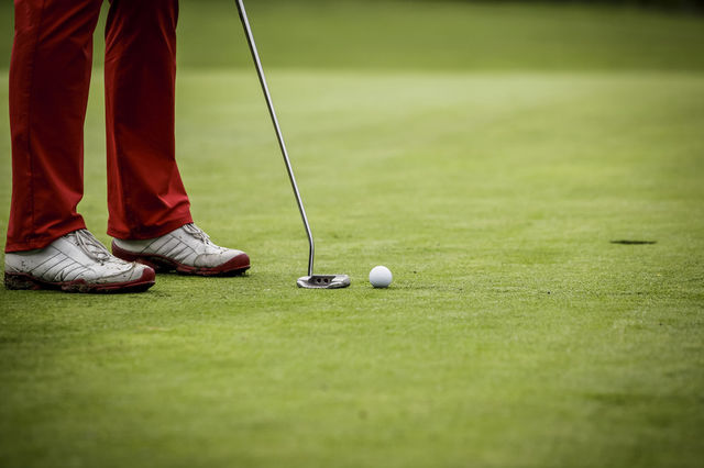 Golf player at hole