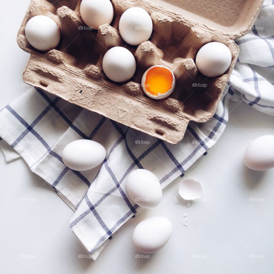 Carton of egg with broken egg inside