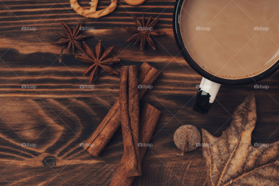 cup of coffee with milk on wooden table. rustic style