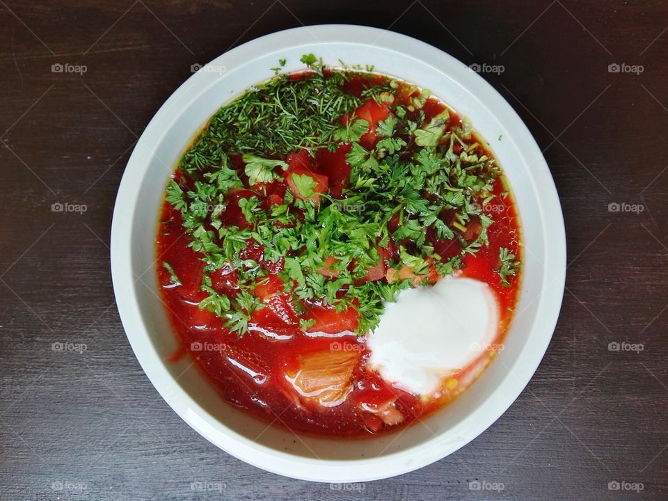 Red beet soup in a white bowl