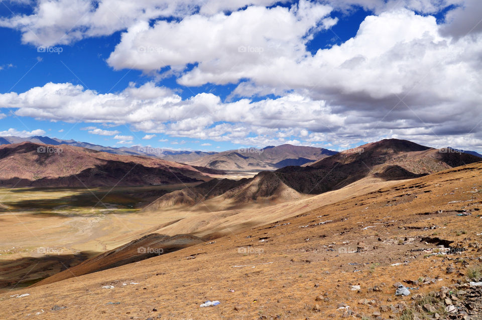 lights and shadows under the clouds in the mountains of Tibet