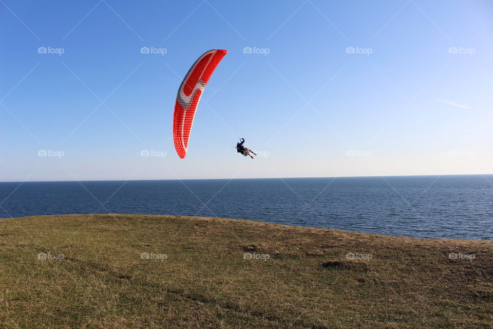 Paraglider by the coast at Kåseberga, Skåne, Sweden.