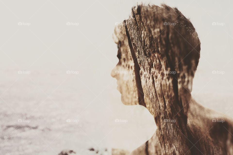 A young man, double exposure of wood