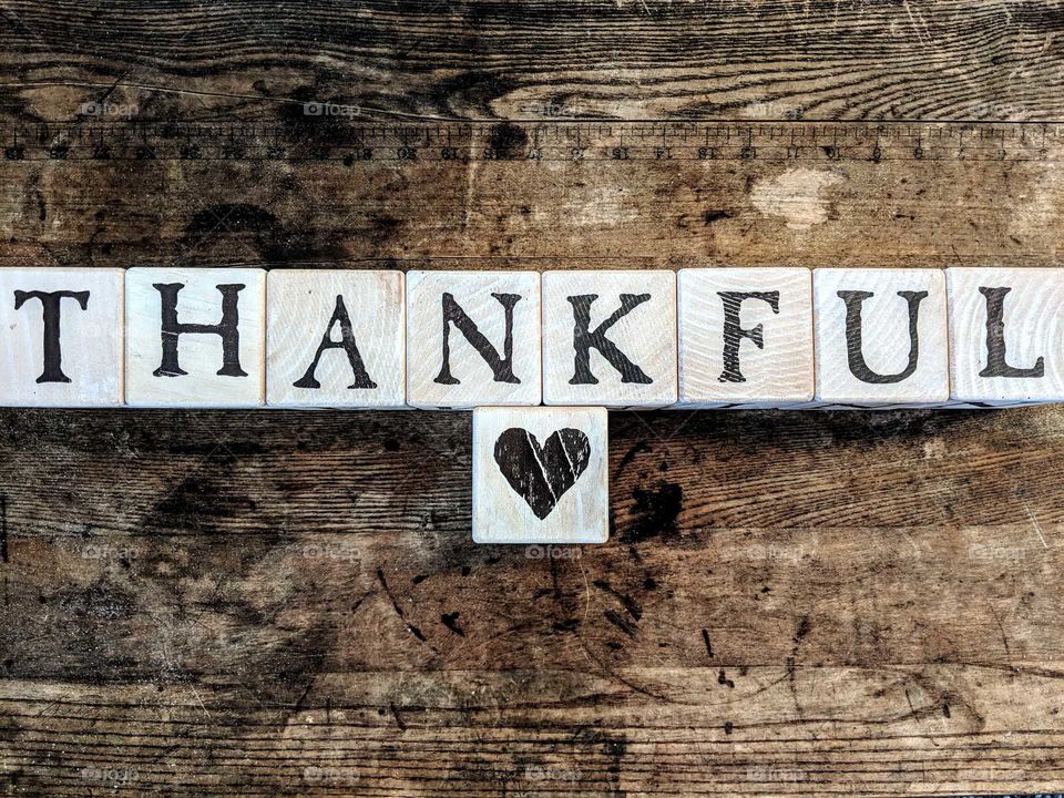 thankful blocks with heart on wooden table