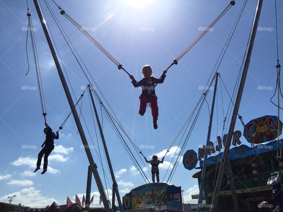 Children jumping at a funfair.