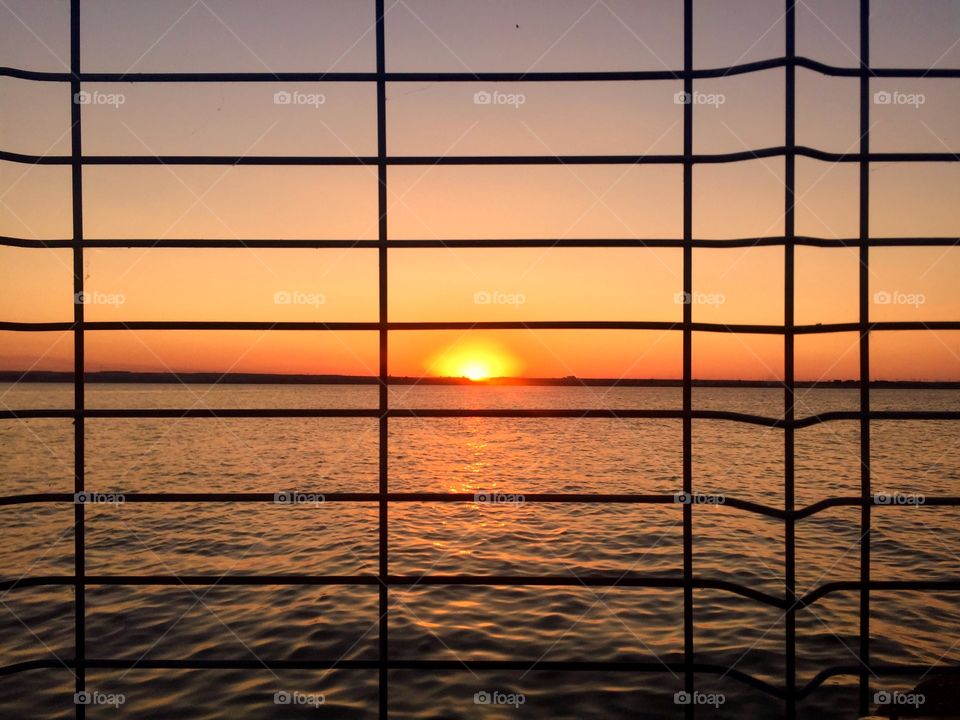 Sunset through metal lines