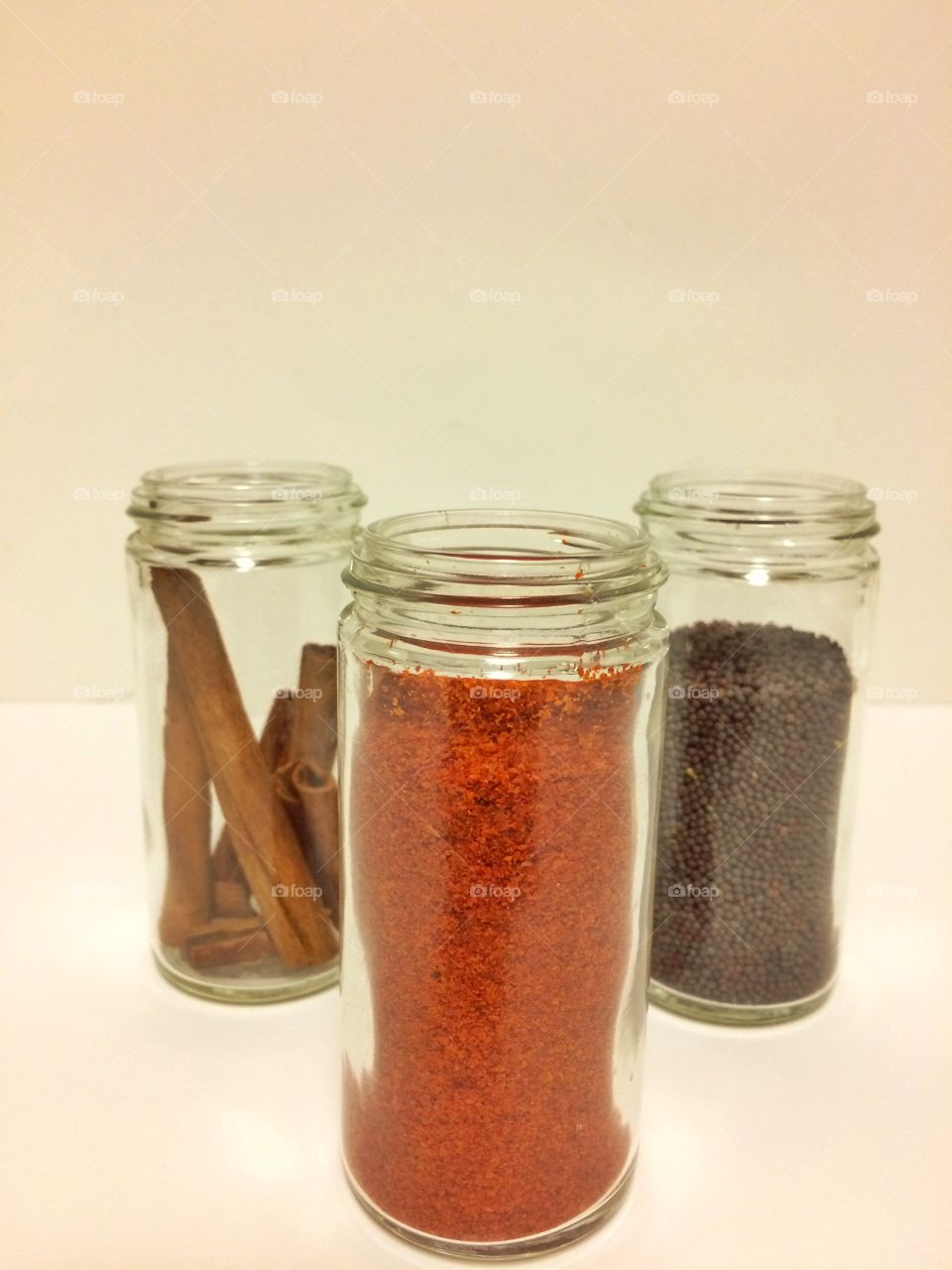 Red chillies and other condiments in glass containers 