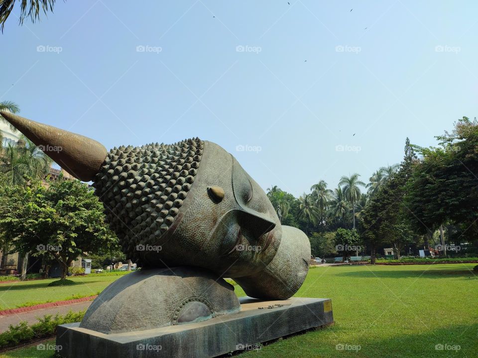 Giant Buddha Head statue in the middle of a ground !