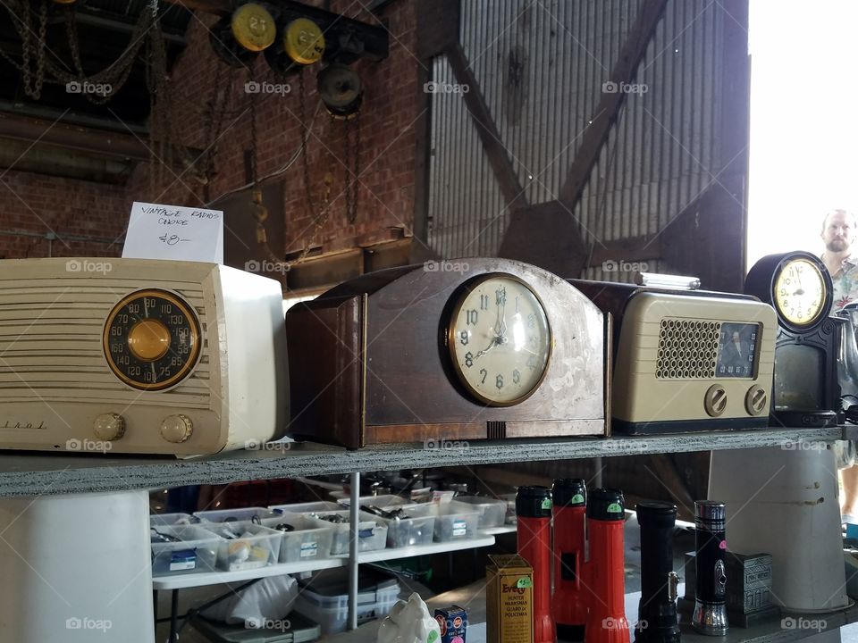 flea market display vintage clocks