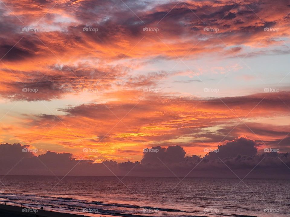 Soft hues of a beautiful sunrise peeking through the  clouds