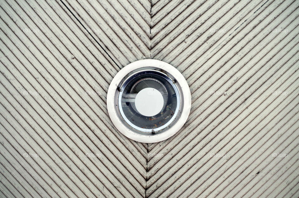 Low angle view of patterned ceiling with lighting equipment.