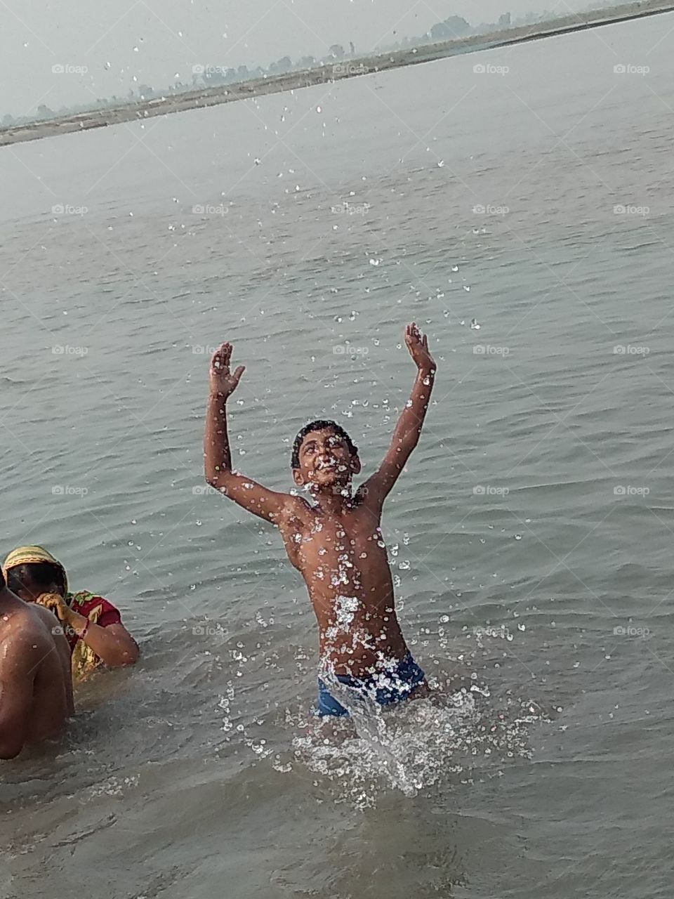 child playing in water/river