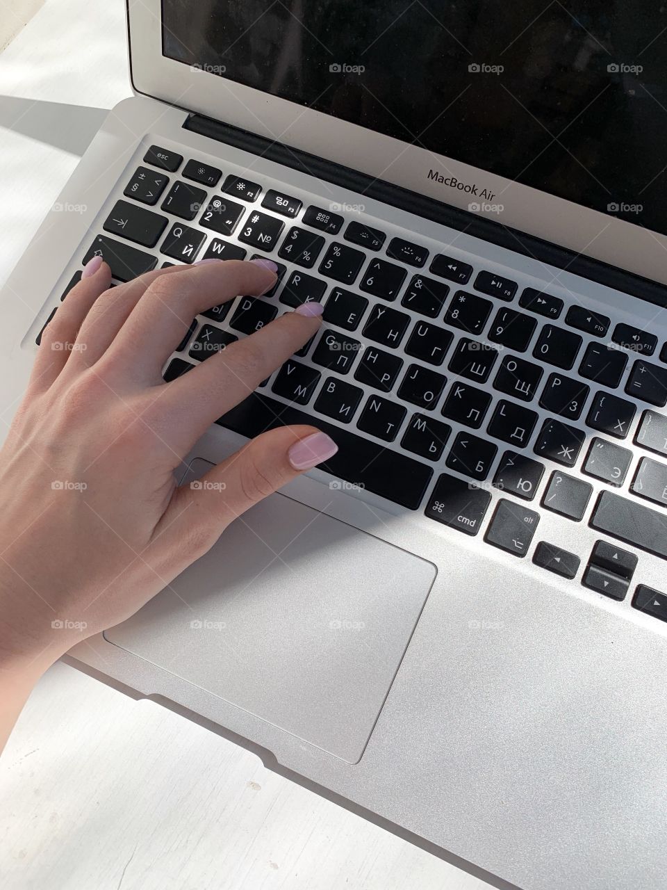Women’s hand on the computer laptop