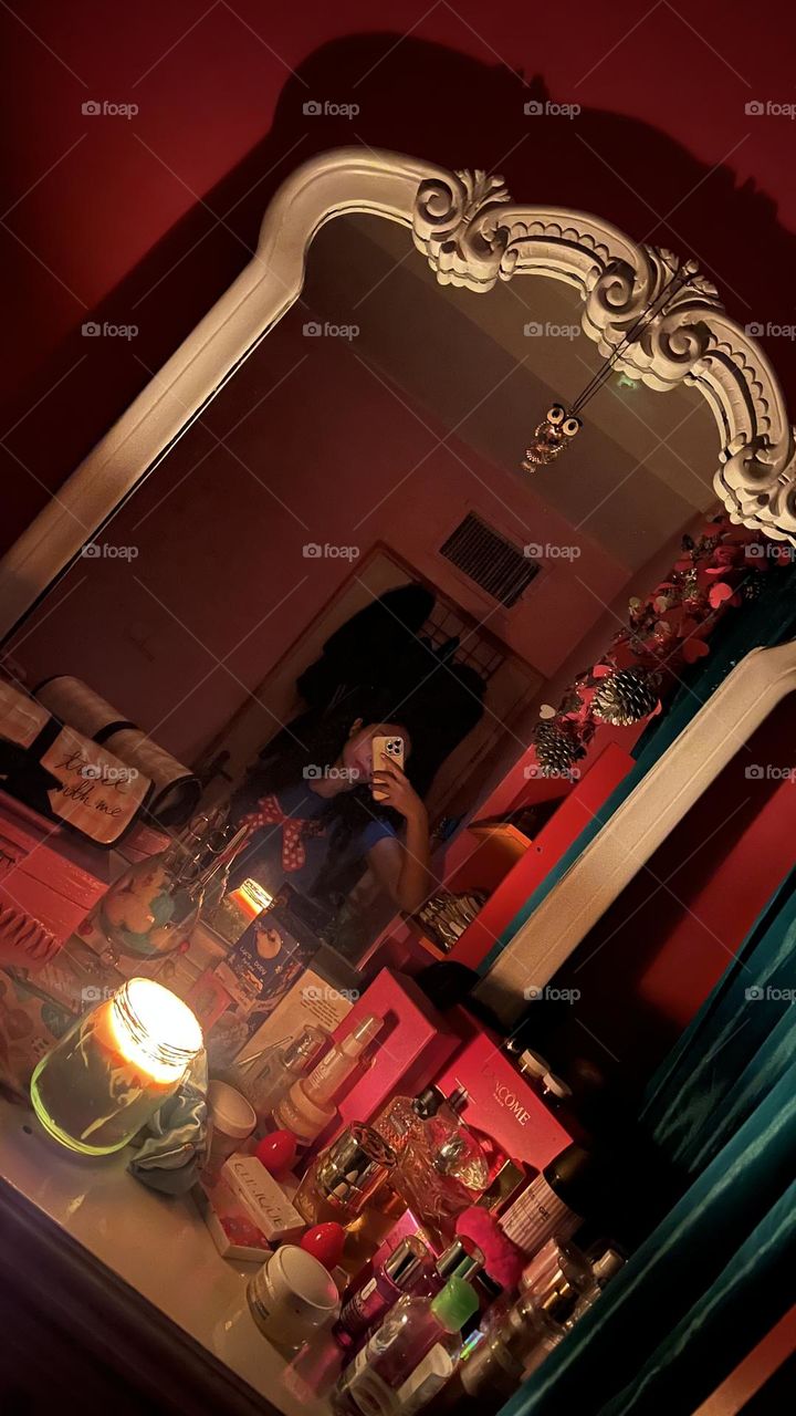 Curly haired girl in a dark room with candlelight