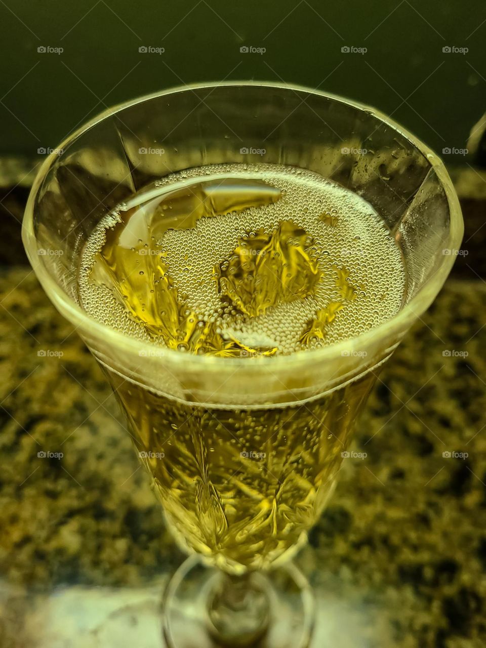 Crystal glass of champagne bubbling away, tasty and sweet as the bubbles tickle your throat 