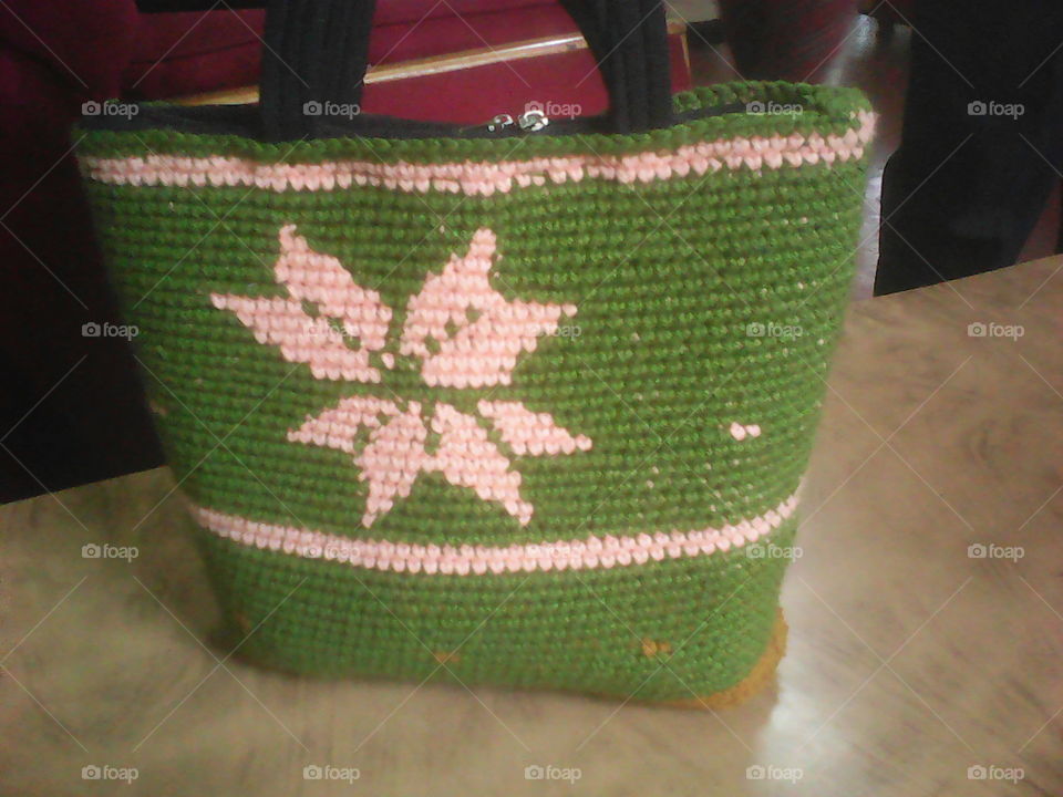 a lady's unique hand bag made of wool.