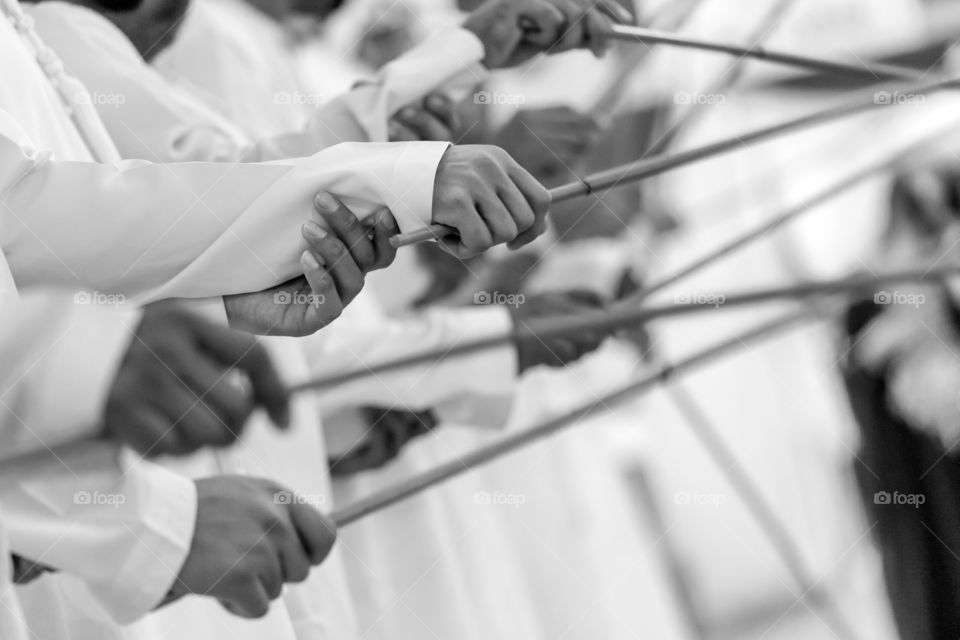 Traditional male arabic dance with sticks, hands in frame