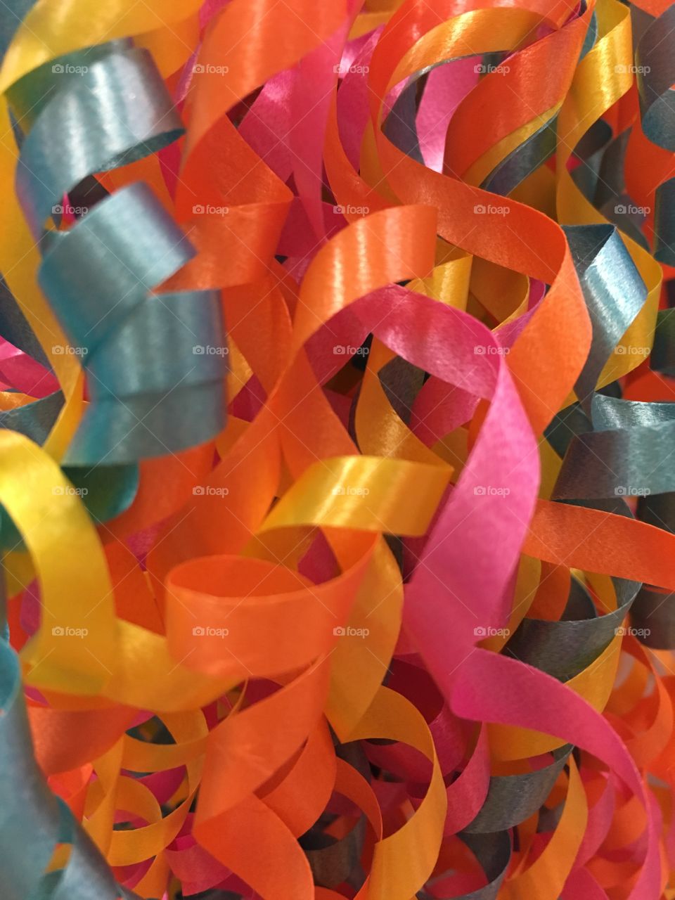 Birthday party colored curled ribbon of pink blue orange yellow 