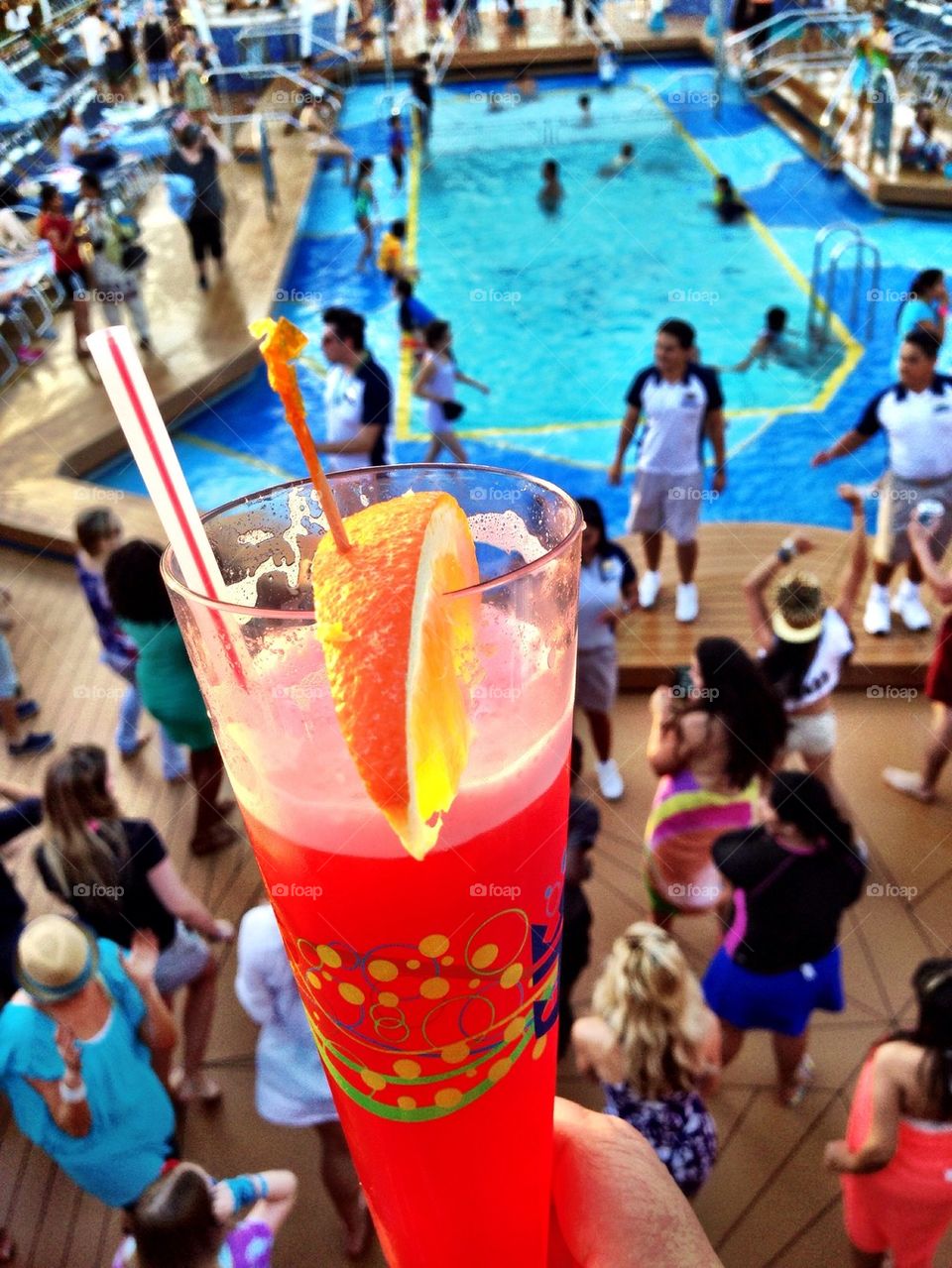 Cocktail glass with people dancing in background