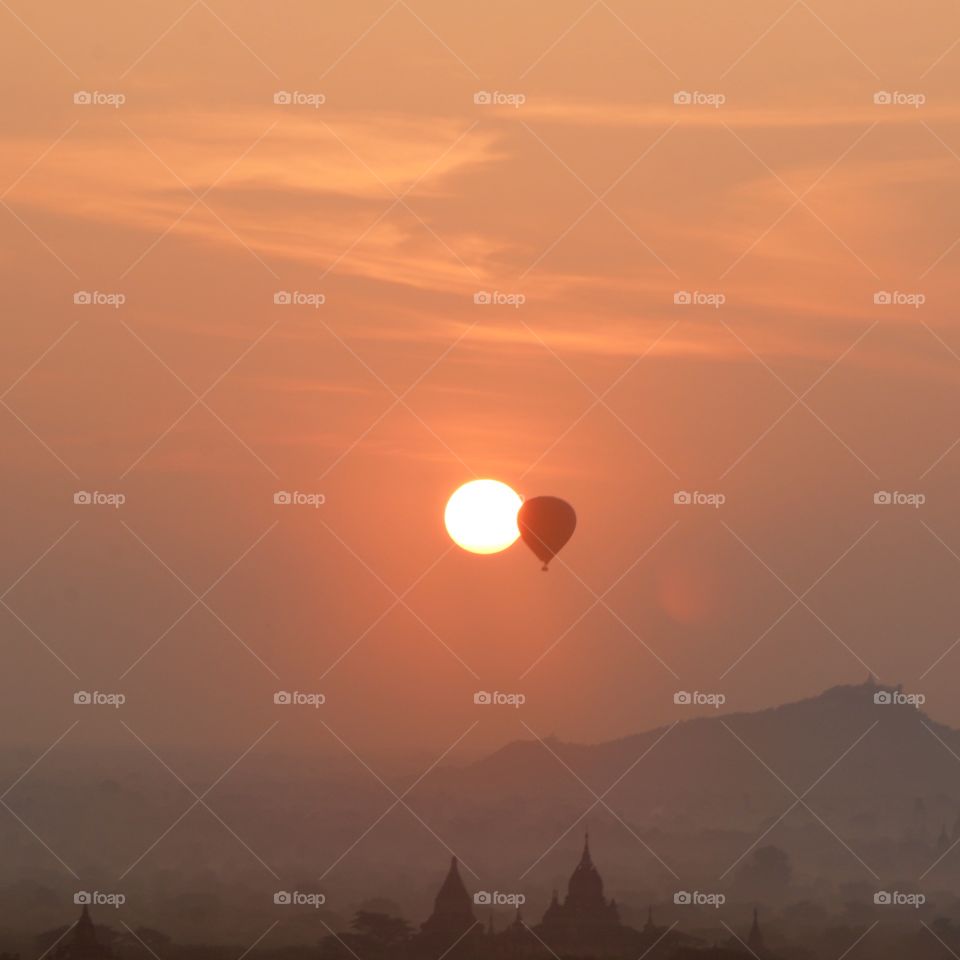 Mystical sunrise balloon entering the sun