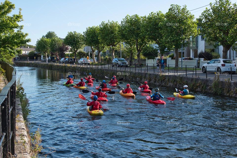 Group of people kayaking in river corrib at Galway City, Ireland