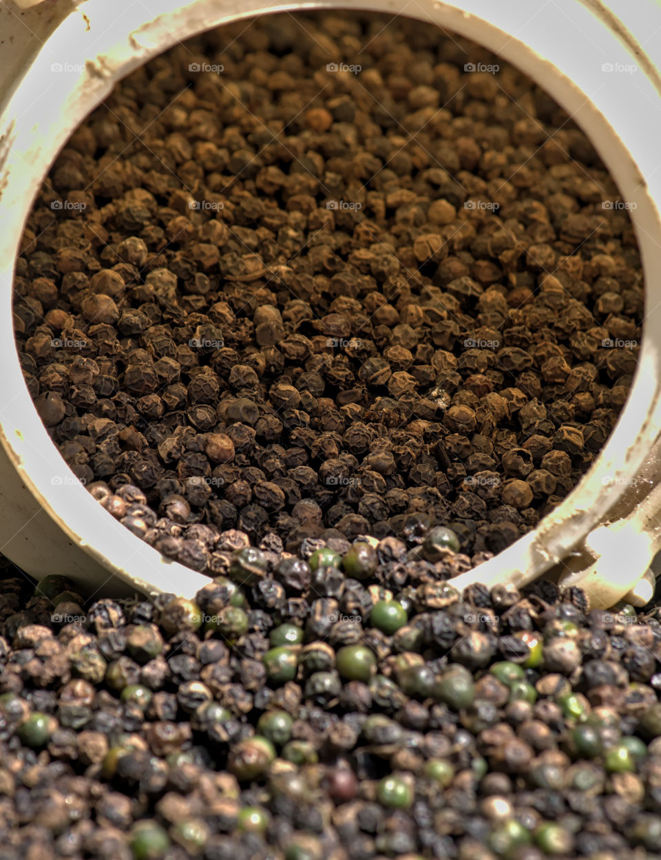 Black pepper dropped from a Jar