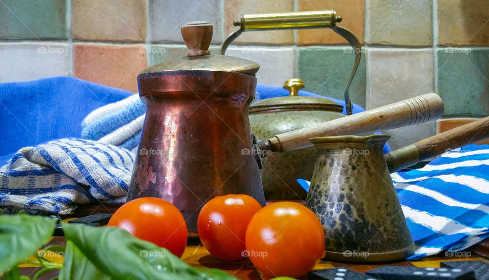 Greek style coffee pots with tomato and basil leaves