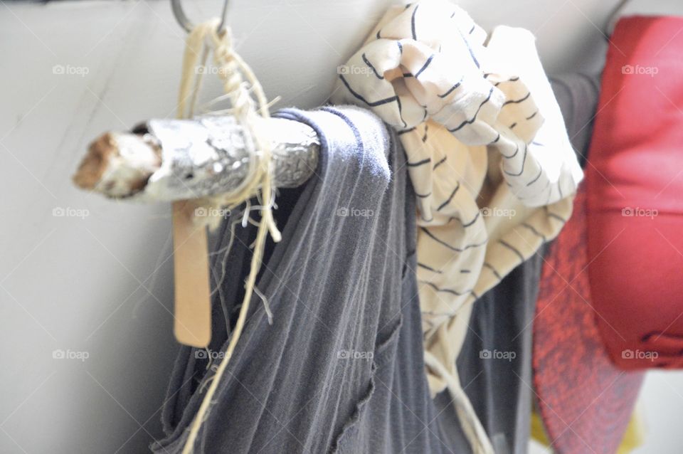 Close-up of clothes and cap hanging on hook