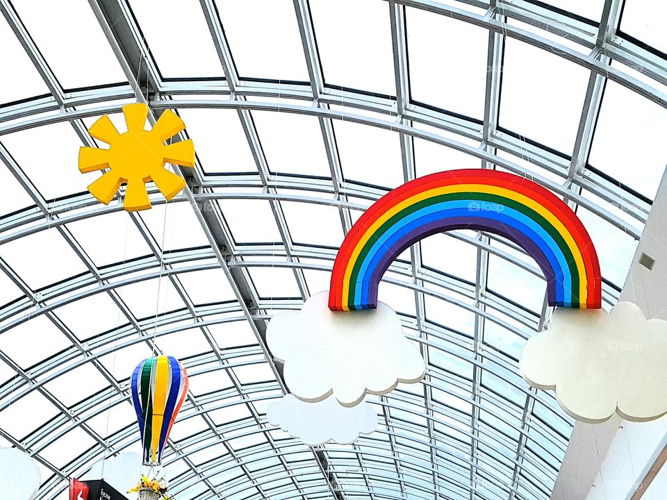 Sun with rainbow and air balloon indoors