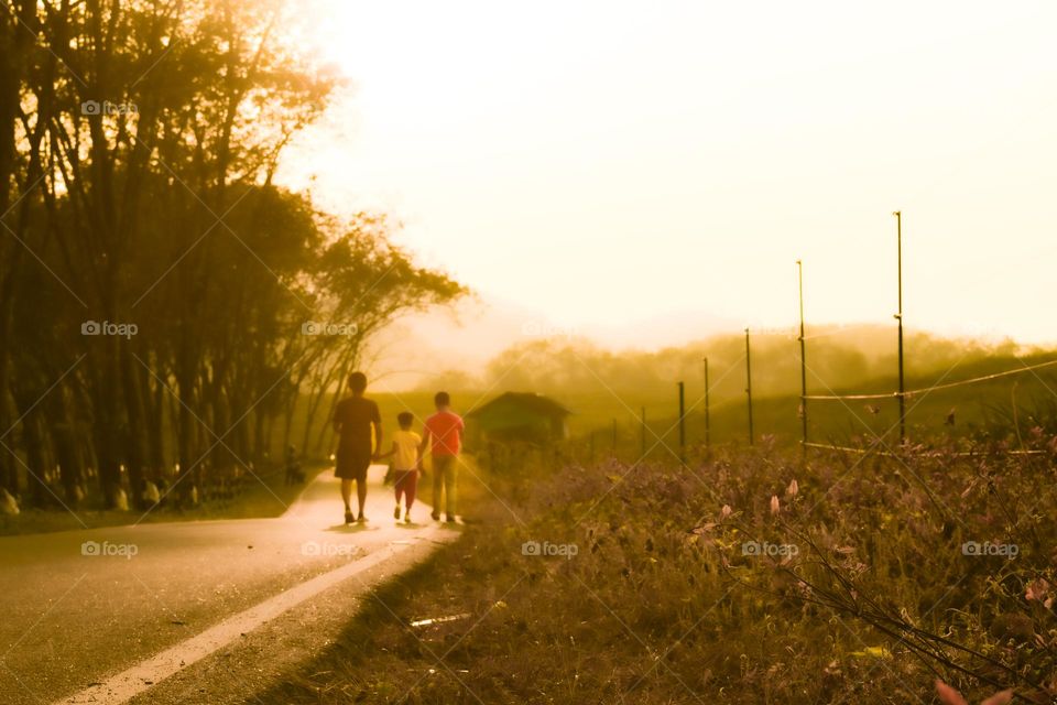 children walking on the road in a beautiful day