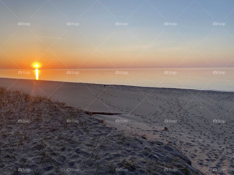 Sunset on a sandy beach on Lake Superior in the Upper peninsula  of Michigan