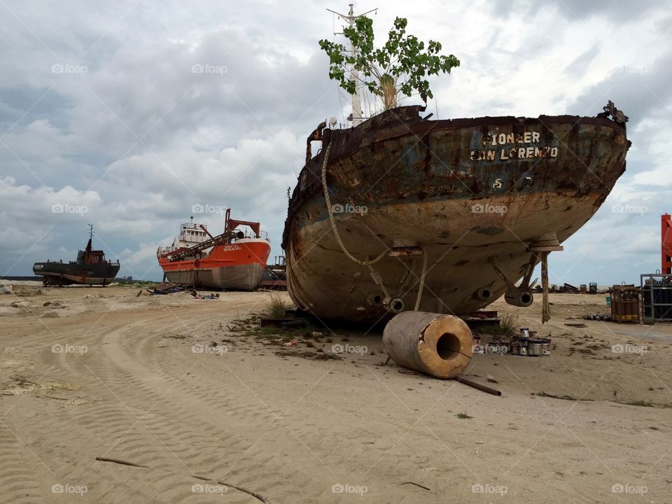 Broken ship stranded at empty land