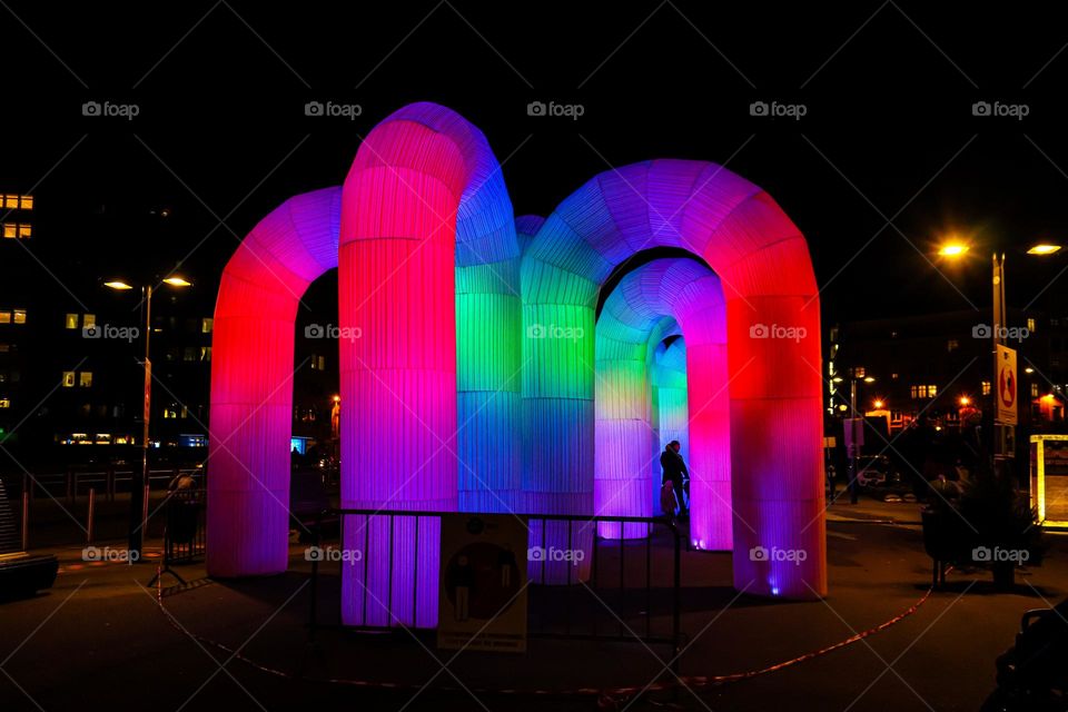 Beautiful view of the neon maze of rubber pipes in the night city of Brussels in Belgium, close-up side view.