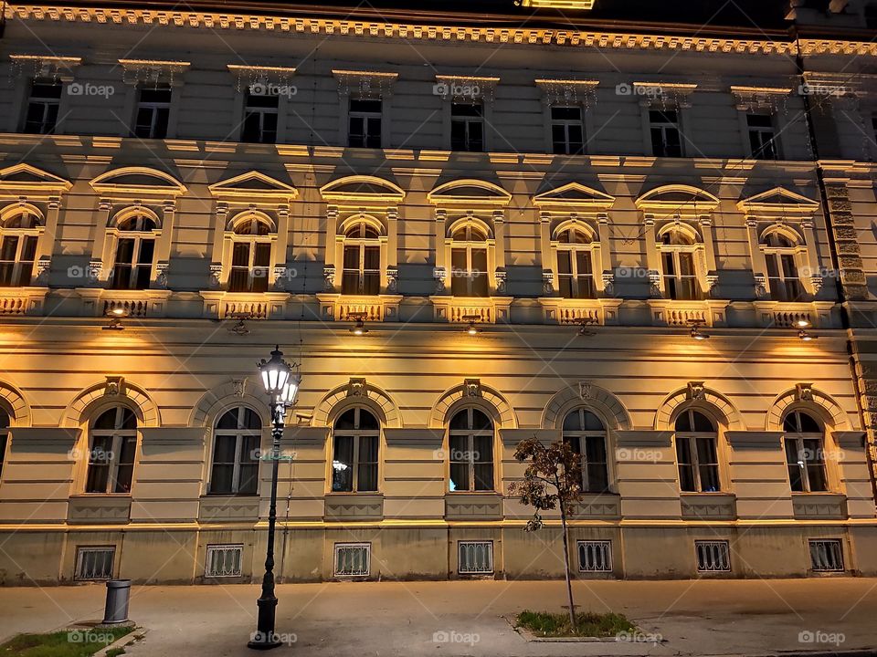 Novi Sad Serbia town hall windows by night yellow facade