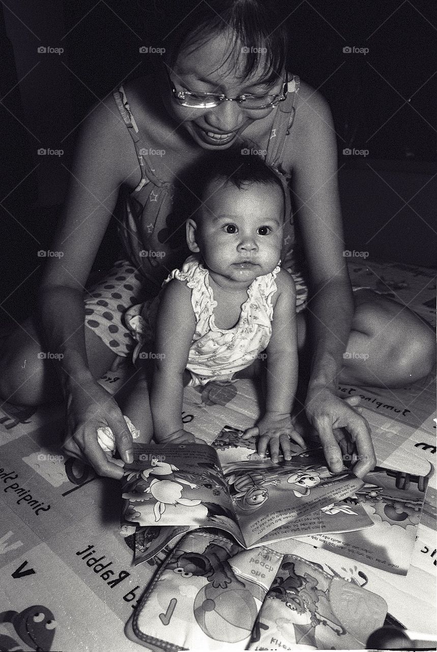 Mum and baby reading books