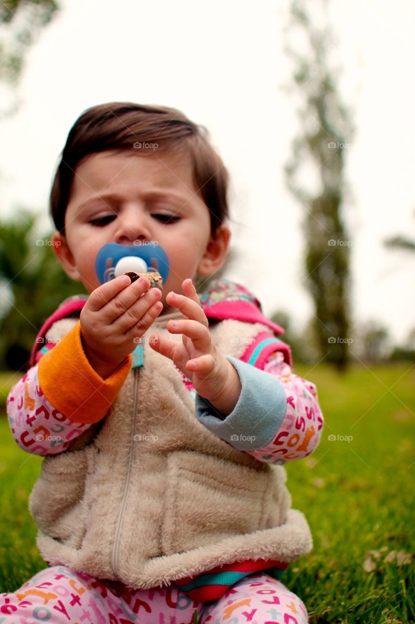 Baby sitting on the grass