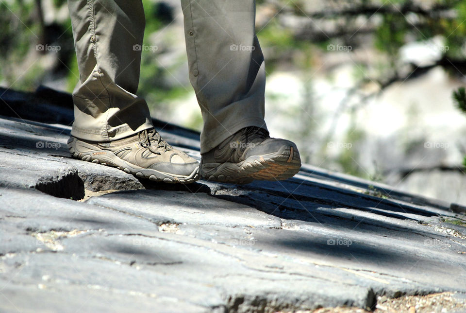 Mountain hike, focus on shoes, blurred view, hiking with a view