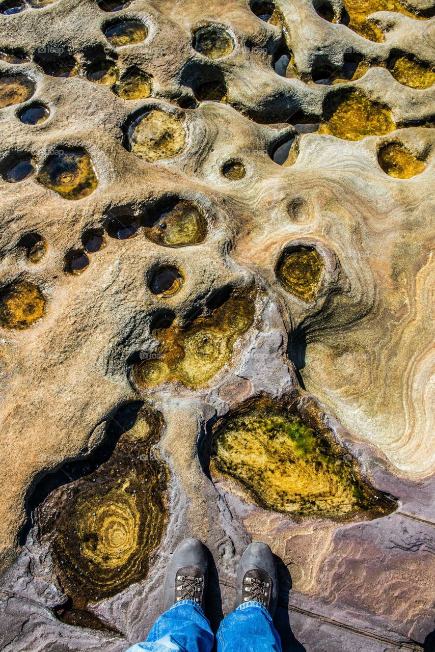 Low section of person standing on rock