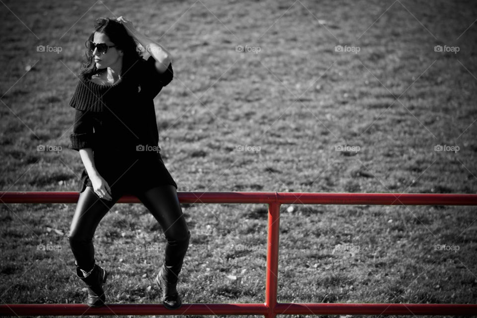 Woman sitting on railing