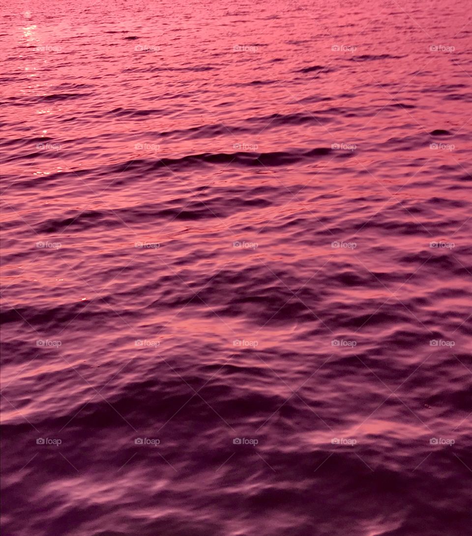 A pink sunset’s reflection in a lake—taken in Ludington, Michigan 