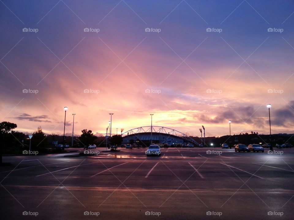 Golden sunset over an empty parking lot.