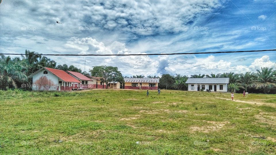 field and school  building at tanjung lanjut