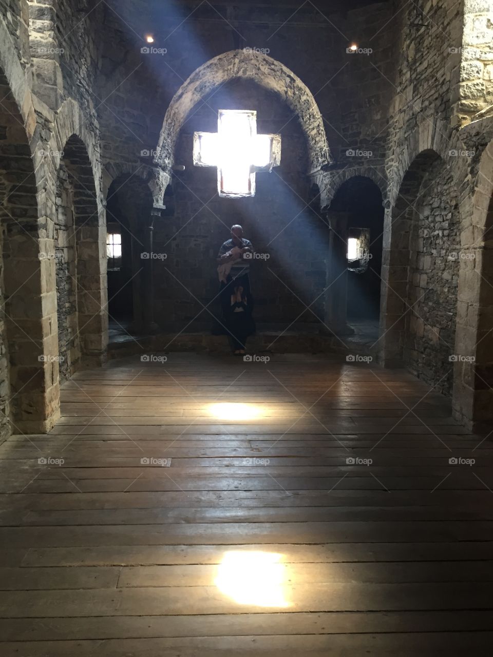 Stunning old castle. Praying under the cross in a castle 