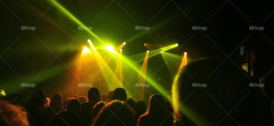 Peatbog Faeries concert in Holmfirth, West Yorkshire, UK. With green and yellow spotlights and crowd.