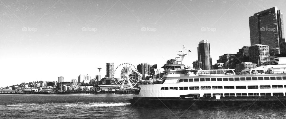 Greyscale Seattle. Black and white photo containing the Space Needle, Ferry, and the Great Wheel of Seattle