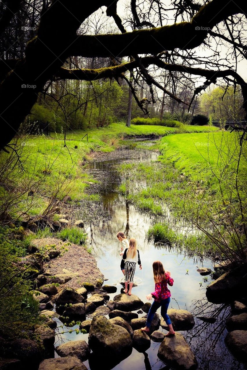 Girls having fun by the creek 